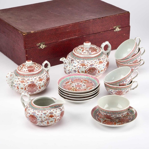 885 - A CHINESE PORCELAIN TEA SERVICE comprising a teapot, cream jug, sucrier, six cups and saucers, each ... 