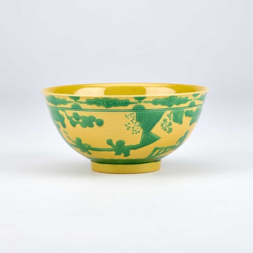 895 - A CHINESE YELLOW AND GREEN ENAMELLED 'BOYS AT PLAY' BOWL with rounded sides rising to a slightly eve... 