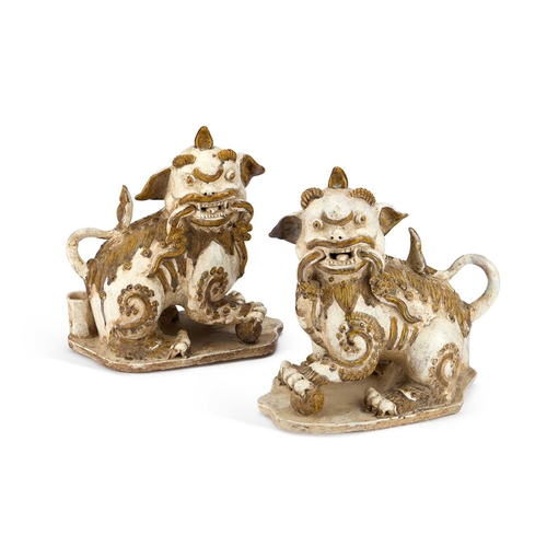 914 - A PAIR OF CHINESE EARTHENWARE BUDDHIST LIONS, 19TH CENTURY OR EARLIER each picked out with ochre col... 