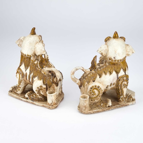 914 - A PAIR OF CHINESE EARTHENWARE BUDDHIST LIONS, 19TH CENTURY OR EARLIER each picked out with ochre col... 