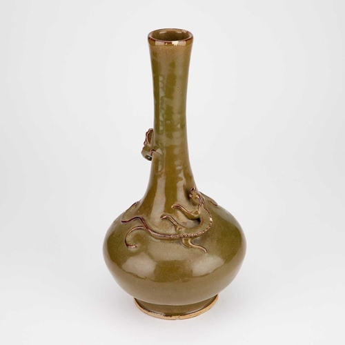 919 - A CHINESE TEA-DUST GLAZED BOTTLE-SHAPED VASE worked with a chi-dragon in high relief. 32cm highOne o... 