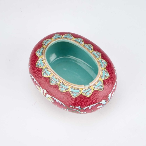 935 - A CHINESE RUBY-GROUND BRUSH WASHER oval, the sgraffito ground enamel painted with flowers and scroll... 