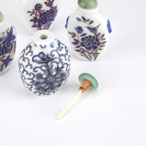 938 - FOUR EARLY 20TH CENTURY CHINESE SNUFF BOTTLES each enamel painted in blue and white, with jade cover... 