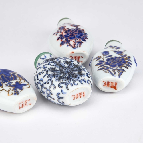 938 - FOUR EARLY 20TH CENTURY CHINESE SNUFF BOTTLES each enamel painted in blue and white, with jade cover... 