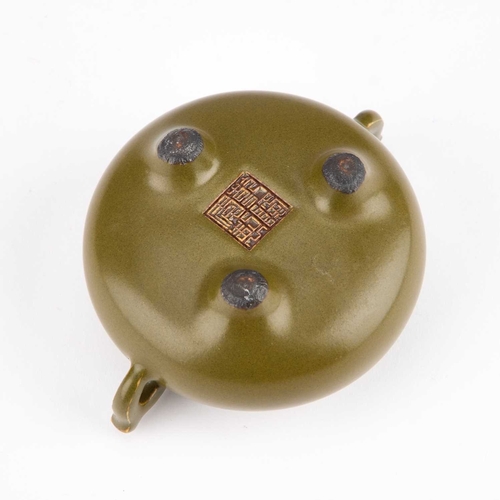 948 - A CHINESE TEA-DUST GLAZED TWO-HANDLED TRIPOD CENSER bears impressed mark. 10.5cm across handlesNo ch... 