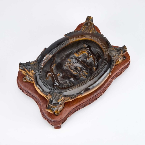 973 - A FINE AND UNUSUAL CHINESE CARVED TIGER'S EYE BRUSH WASHER on a fitted carved hardwood stand, of ova... 