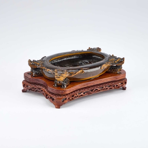 973 - A FINE AND UNUSUAL CHINESE CARVED TIGER'S EYE BRUSH WASHER on a fitted carved hardwood stand, of ova... 