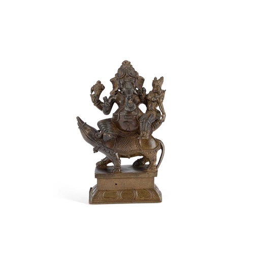 989 - A BRONZE FIGURE OF GANESH cast sitting on the back of a creature. 14.5cm high