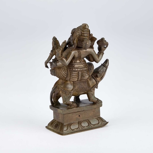 989 - A BRONZE FIGURE OF GANESH cast sitting on the back of a creature. 14.5cm high