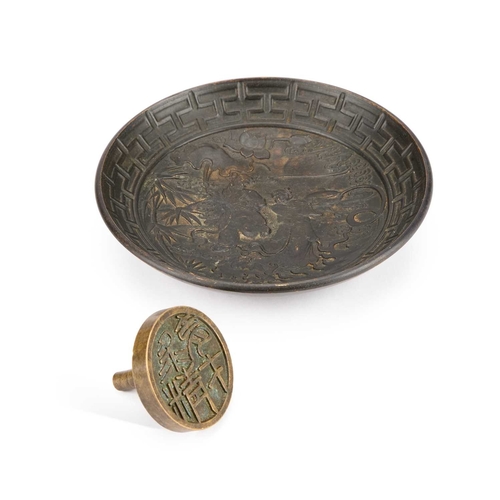 995 - A CHINESE BRONZE SEAL AND A BRONZE DISH the dish cast with figures. (2) Dish 15cm diameter