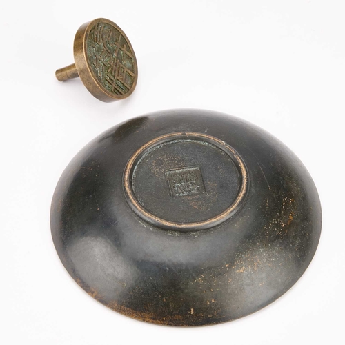 995 - A CHINESE BRONZE SEAL AND A BRONZE DISH the dish cast with figures. (2) Dish 15cm diameter