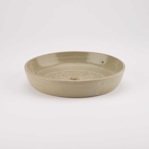 149 - A CHINESE CELADON BRUSH WASHER circular, moulded in relief with a Kylin. 17.5cm diameter