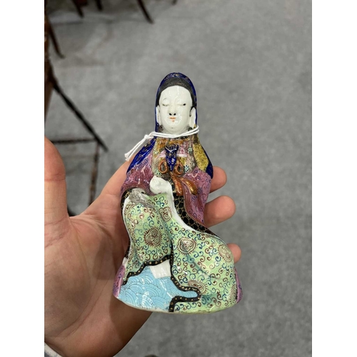 153 - V A CHINESE FAMILLE ROSE FIGURE OF GUANYIN probably 19th Century, modelled seated, on a later wooden... 