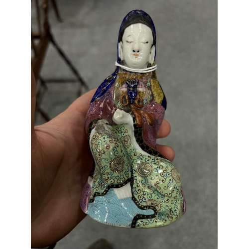 153 - V A CHINESE FAMILLE ROSE FIGURE OF GUANYIN probably 19th Century, modelled seated, on a later wooden... 