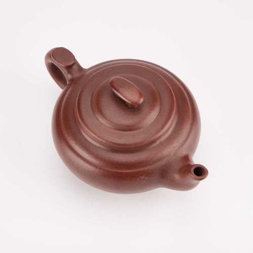 154 - A CHINESE YIXING TEAPOT bears an impressed mark. 20cm long