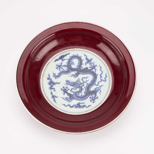 157 - A CHINESE UNDERGLAZE BLUE AND SANG-DE-BOEUF 'DRAGON' DISH circular, painted to the centre with a dra... 