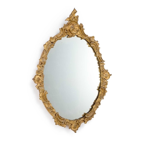 291 - A ROCOCO REVIVAL GILTWOOD MIRROR, 19TH CENTURY oval. 79cm by 56cm