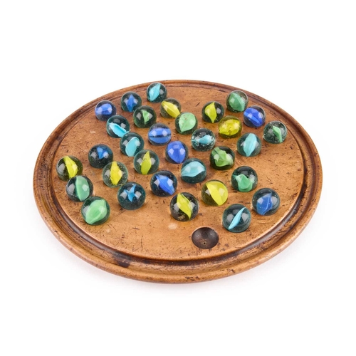 292 - A VICTORIAN WALNUT SOLITAIRE BOARD with a group of marbles. Board 20vm diameter