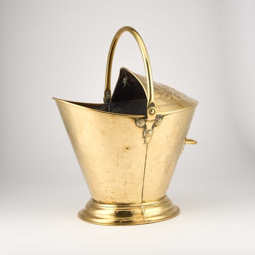 122 - A BRASS COAL BUCKET, CIRCA 1880 the canopy embossed with stylised flowers below a swing-handle. 49cm... 