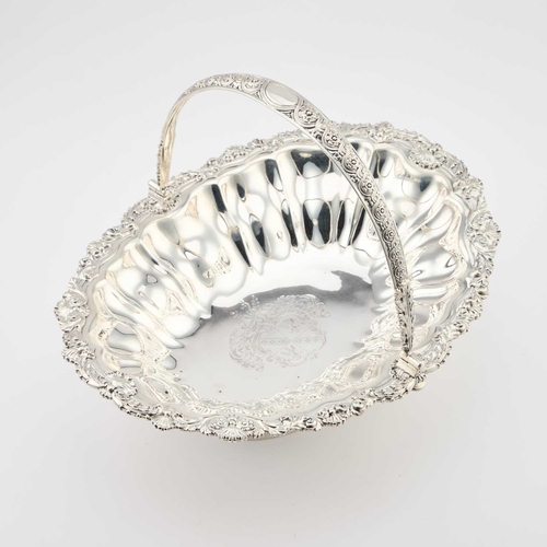 145 - A GEORGE IV SILVER CAKE BASKET by Paul Storr, London 1820, of lobed and fluted boat form, on a pedes... 