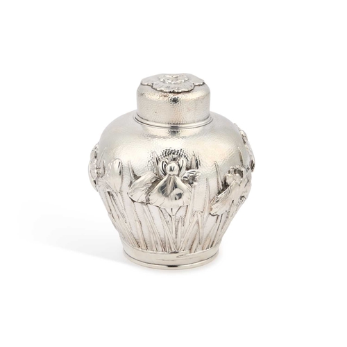 160 - A JAPANESE SILVER TEA CADDY signed, Meiji period (1868-1912), boldly repoussé with irises against a ... 