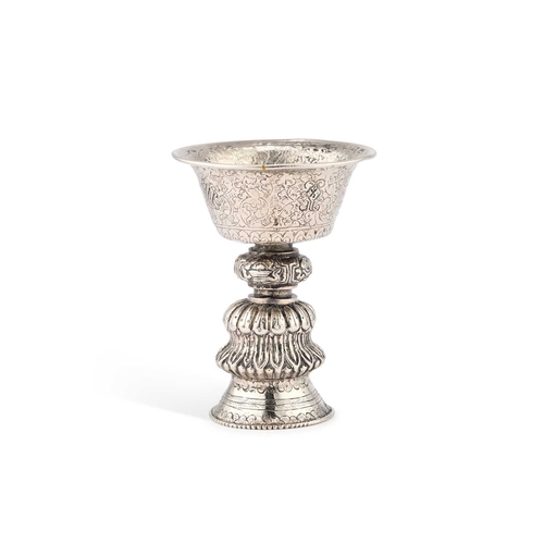 163 - A TIBETAN DIPA SILVERED BUTTER OIL LAMP 19th Century, with a hollow stem foot encircled by a band of... 