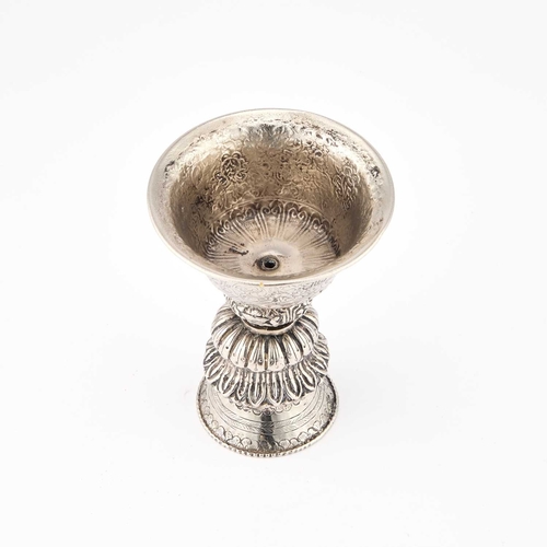 163 - A TIBETAN DIPA SILVERED BUTTER OIL LAMP 19th Century, with a hollow stem foot encircled by a band of... 