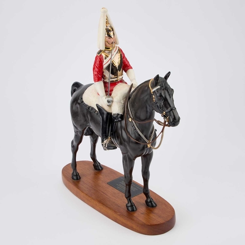 24 - A BESWICK MODEL OF A 'LIFE GUARD' Connoisseur Model, on a wooden plinth. 36.5cm high