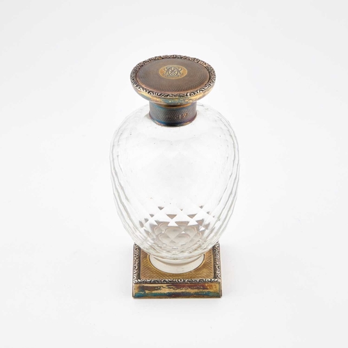 249 - A LARGE GEORGE V SILVER-GILT AND GLASS SCENT BOTTLE maker NM, London 1914, the engine-turned screw-d... 