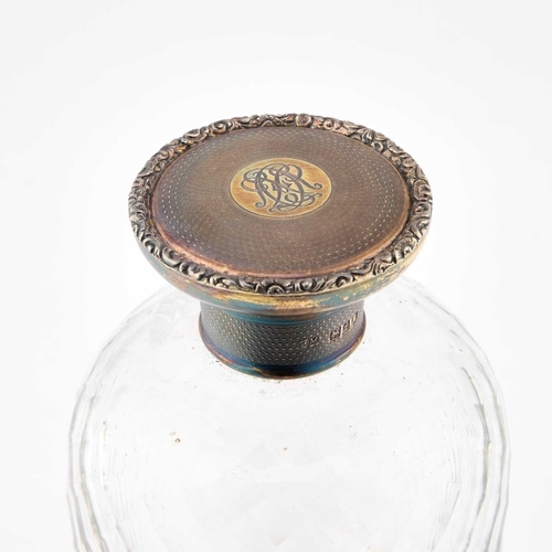 249 - A LARGE GEORGE V SILVER-GILT AND GLASS SCENT BOTTLE maker NM, London 1914, the engine-turned screw-d... 