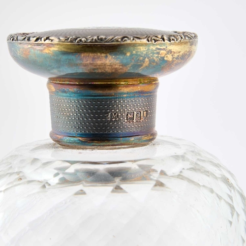 249 - A LARGE GEORGE V SILVER-GILT AND GLASS SCENT BOTTLE maker NM, London 1914, the engine-turned screw-d... 