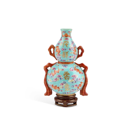 61 - A CHINESE TURQUOISE-GROUND FAMILLE ROSE WALL VASE the gourd-shaped vase modelled with trailing ribbo... 