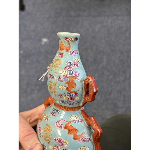 61 - A CHINESE TURQUOISE-GROUND FAMILLE ROSE WALL VASE the gourd-shaped vase modelled with trailing ribbo... 