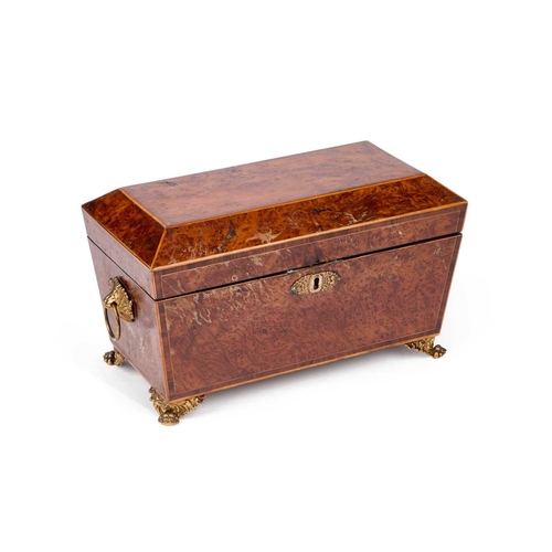 786 - AN EARLY 19TH CENTURY BURR YEW TEA CADDY of sarcophagus form, with twin lion-mask ring handles and p... 