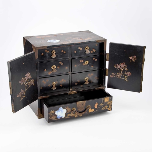 85 - A JAPANESE LACQUER AND PORCELAIN-MOUNTED KODANSU (CABINET) with a pair of panel doors opening to rev... 