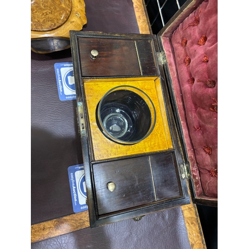 1000 - AN EARLY 19TH CENTURY BURR YEW TEA CADDY of sarcophagus form, with twin lion-mask ring handles and p... 