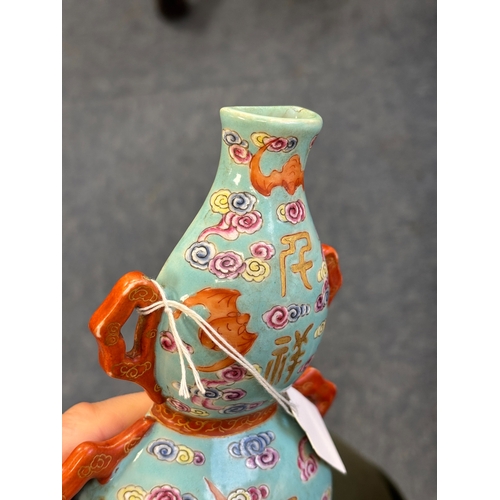 101 - A CHINESE TURQUOISE-GROUND FAMILLE ROSE WALL VASE the gourd-shaped vase modelled with trailing ribbo... 