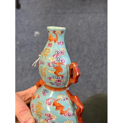 101 - A CHINESE TURQUOISE-GROUND FAMILLE ROSE WALL VASE the gourd-shaped vase modelled with trailing ribbo... 