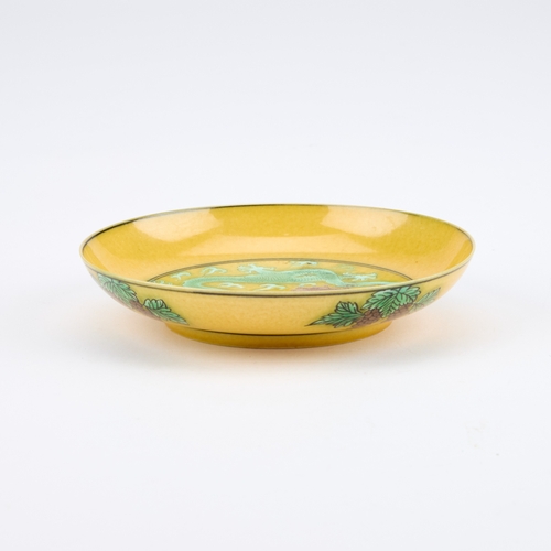 111 - A CHINESE YELLOW-GROUND 'DRAGON' DISH circular, painted with two dragons chasing a flaming pearl, be... 