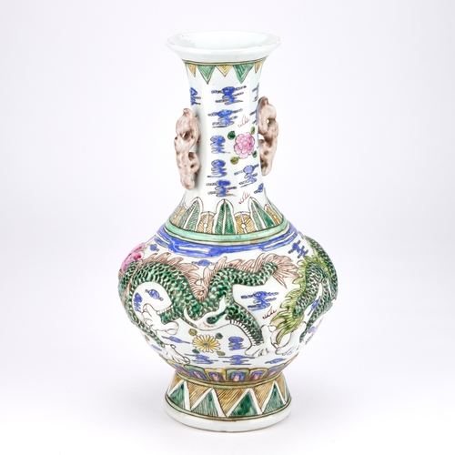 115 - A LARGE CHINESE FAMILLE ROSE MOULDED PORCELAIN VASE with a squat circular body and high flared neck,... 