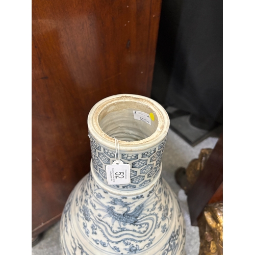 132 - A LARGE CHINESE YUAN-STYLE BLUE AND WHITE PEAR-SHAPED 'DRAGON' VASE decorated with dragons above cra... 