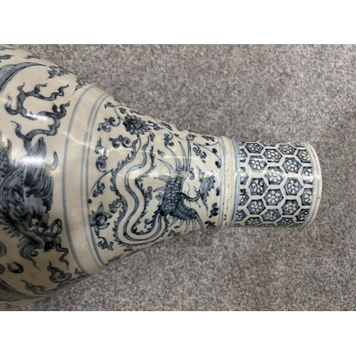 132 - A LARGE CHINESE YUAN-STYLE BLUE AND WHITE PEAR-SHAPED 'DRAGON' VASE decorated with dragons above cra... 