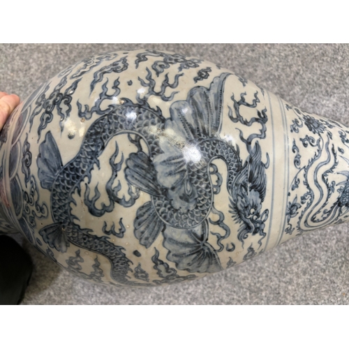 132 - A LARGE CHINESE YUAN-STYLE BLUE AND WHITE PEAR-SHAPED 'DRAGON' VASE decorated with dragons above cra... 