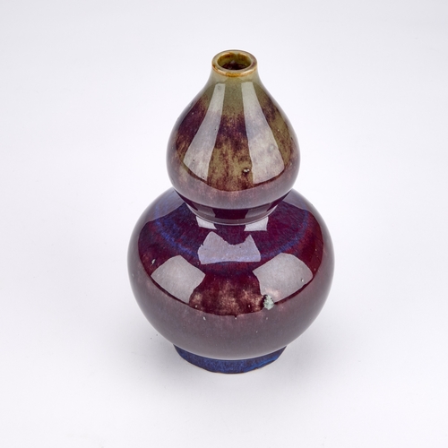 158 - A CHINESE SANG-DE-BOEUF DOUBLE GOURD VASE covered in a lustrous ox-blood glaze pooling slightly at t... 