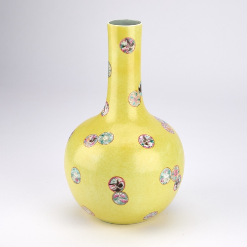 162 - A CHINESE FAMILLE ROSE SGRAFFITO PORCELAIN BOTTLE VASE WITH A YELLOW GROUND of compressed globular f... 