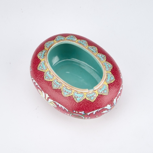 166 - A CHINESE RUBY-GROUND BRUSH WASHER oval, the sgraffito ground enamel painted with flowers and scroll... 