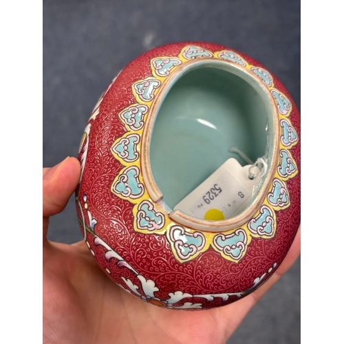 166 - A CHINESE RUBY-GROUND BRUSH WASHER oval, the sgraffito ground enamel painted with flowers and scroll... 