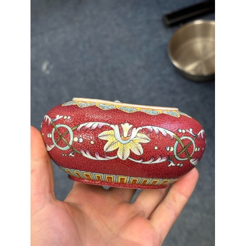 166 - A CHINESE RUBY-GROUND BRUSH WASHER oval, the sgraffito ground enamel painted with flowers and scroll... 