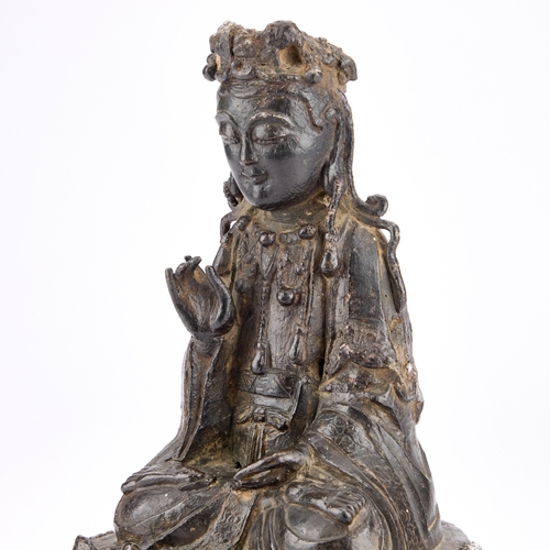 172 - A CHINESE BRONZE BUDDHA, MING DYNASTY seated on a lotus base. 26cm high