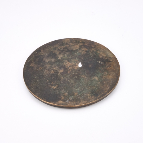 174 - A CHINESE BRONZE MIRROR circular form, with geometric and character borders. 16.5cm diameter